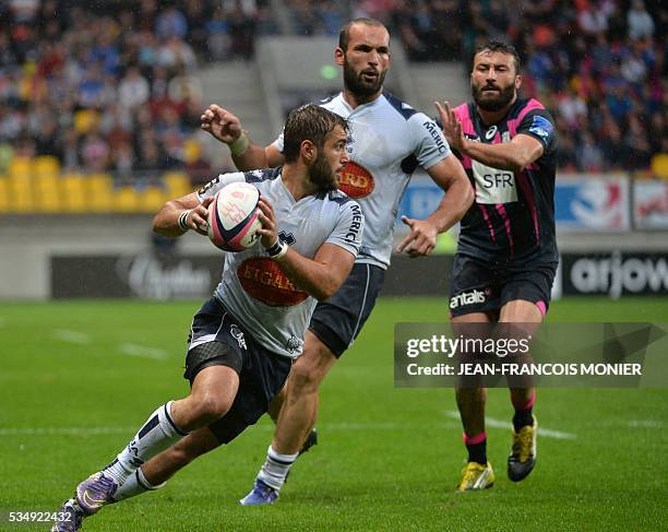 Agen's French scrumhalf Paul Abadie runs with the ball during the French Top 14 rugby union match between Agen and Stade Français on May 28, 2016 at...