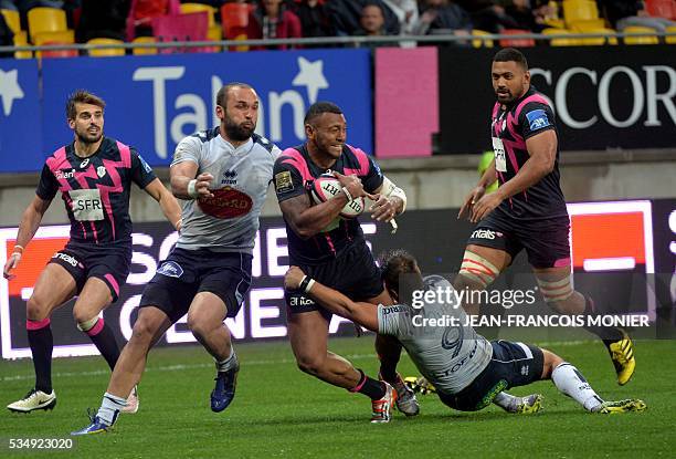 Stade Francais Paris' Fijian wing Waisea is tackled by Agen's French scrumhalf Paul Abadie during the French Top 14 rugby union match between Agen...