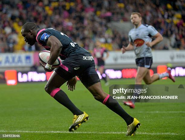 Stade Francais Paris' French fullback Djibril Camara scores a try during the French Top 14 rugby union match between Agen and Stade Français on May...