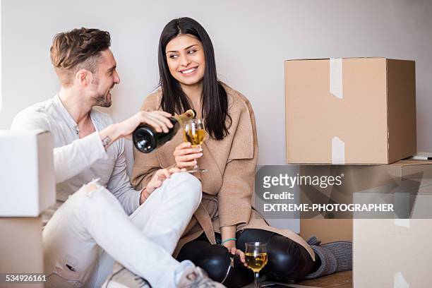 couple celebrating new apartment - honors 2015 arrivals stock pictures, royalty-free photos & images