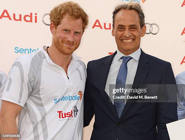 Prince Harry and Andre Konsbruck, Director of Audi UK, attend day one of the Audi Polo Challenge at Coworth Park on May 28, 2016 in London, England.