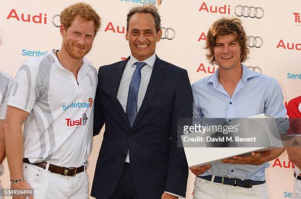 Prince Harry, Andre Konsbruck, Director of Audi UK, and William Melville-Smith attend day one of the Audi Polo Challenge at Coworth Park on May 28,...