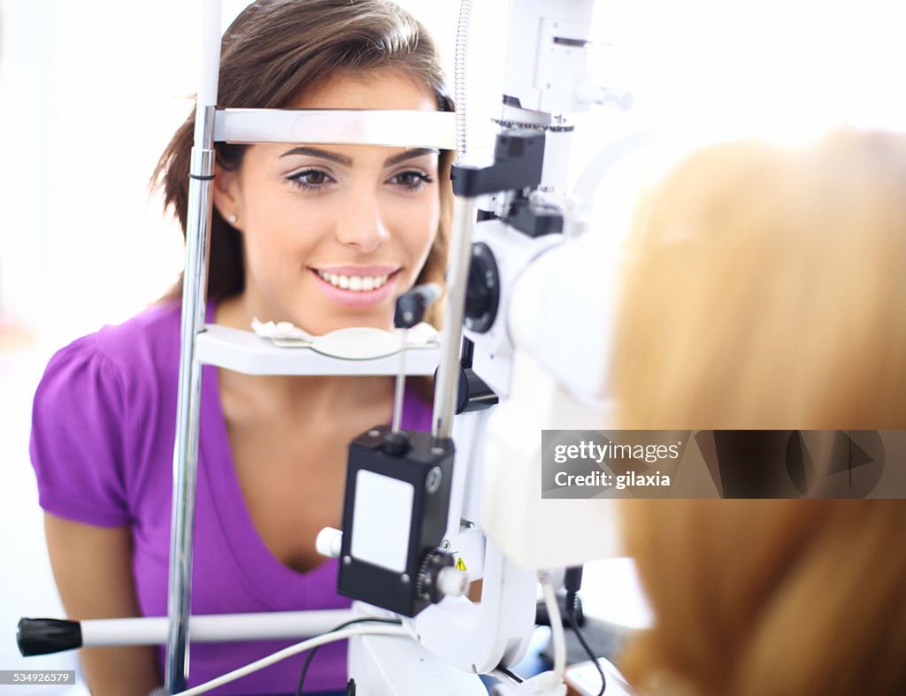 Young woman at optician.