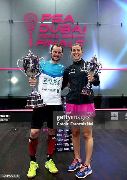 Gregory Gaultier of France and Laura Massaro of England pose with the winners trophys after the PSA Dubai World Series Finals 2016 at Burj Park on...