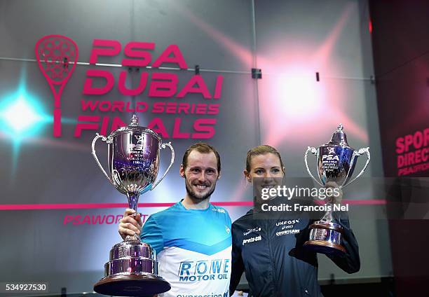 Gregory Gaultier of France and Laura Massaro of England pose with the winners trophys after PSA Dubai World Series Finals 2016 at Burj Park on May...
