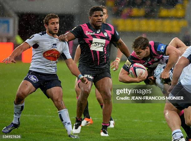 Stade Francais Paris' French scrumhalf Clement Daguin is tackled during the French Top 14 rugby union match between Agen and Stade Français on May...
