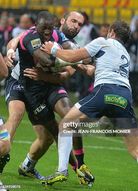 Stade Francais Paris' French fullback Djibril Camara is tackled during the French Top 14 rugby union match between Agen and Stade Français , on May...