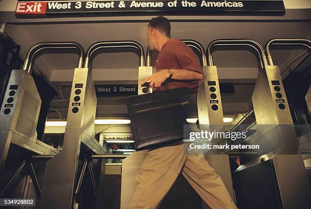 Man rushes to catch the subway at the West 4th Street station in New York City.