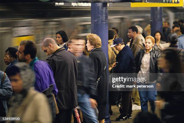 Commuters waiting on platform in the 53rd and Lexington Ave. Subway station in New York City.