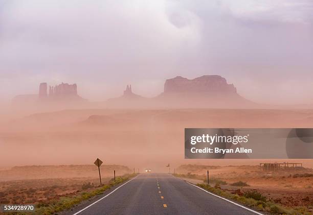 car driving through dust storm in monument valley - dust storm stock pictures, royalty-free photos & images