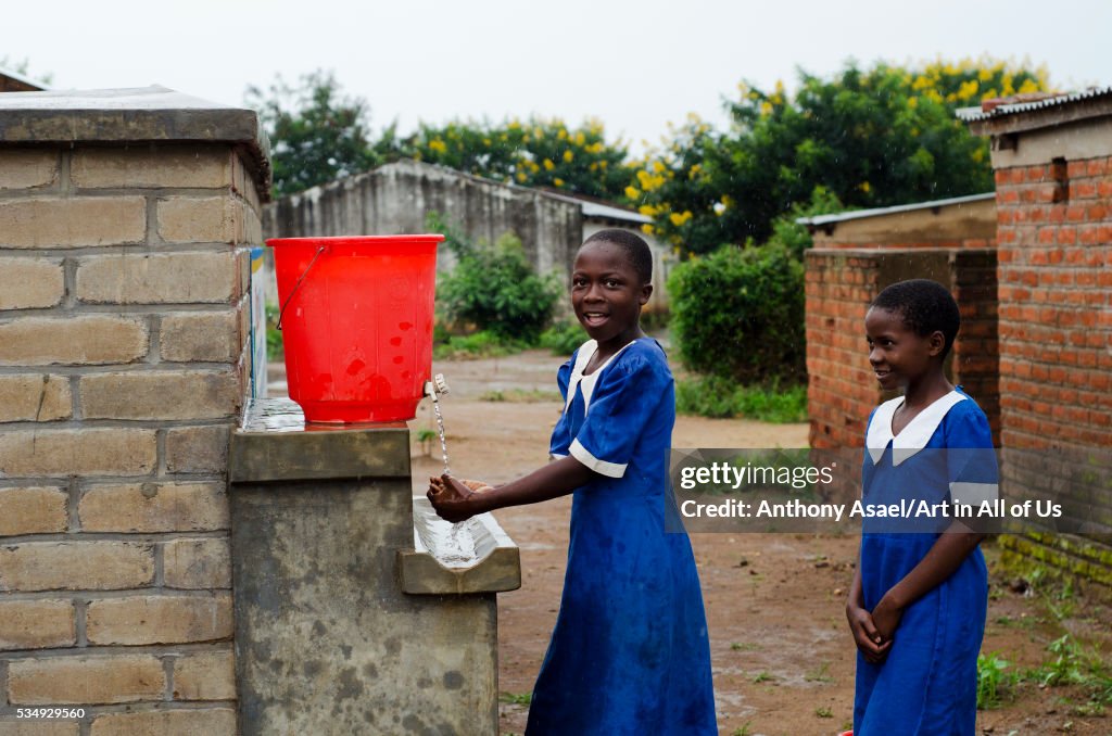 Malawi, Lilongwe, Chambwe Primary School, pupils washing hands after using the sanitary facilities b