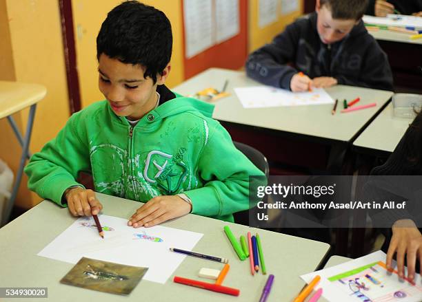 Belgium, Asse, Basisschool Vijverbeek, Art in All of Us Awareness program activities in scool, boy drawing