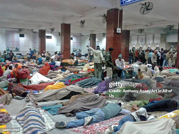 India, Bihar, Patna, crowded train station at night with people sleeping on the ground