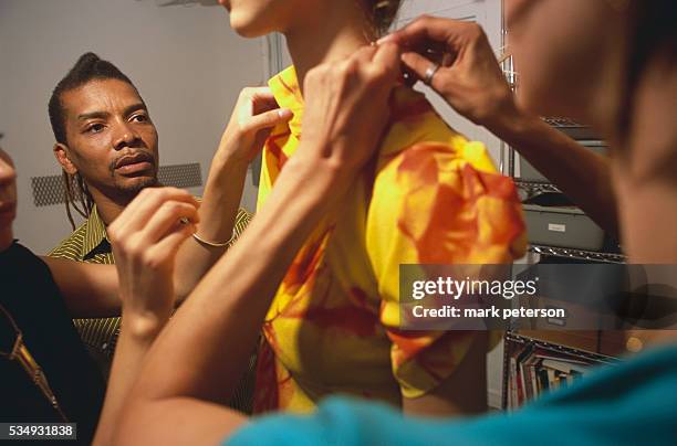 Douglas Hobbs, designer of the Dugg label, fits model Zuzana in a Manhattan studio.