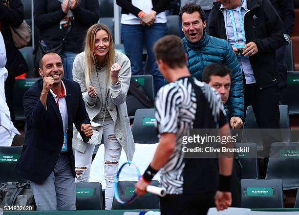 Ester Satorova the wife of Tomas Berdych of Czech Republic applauds his victory during the Men's Singles third round match against Pablo Cuevas of...