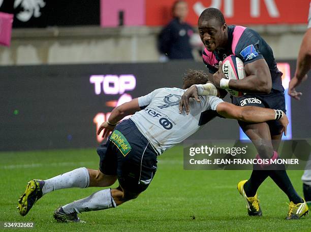 Stade Francais Paris' French fullback Djibril Camara is tackled by Agen's French scrumhalf Paul Abadie during the French Top 14 rugby union match...