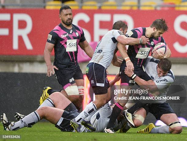 Stade Francais Paris' French fullback Hugo Bonneval is tackled during the French Top 14 rugby union match between Agen and Stade Français , on May...