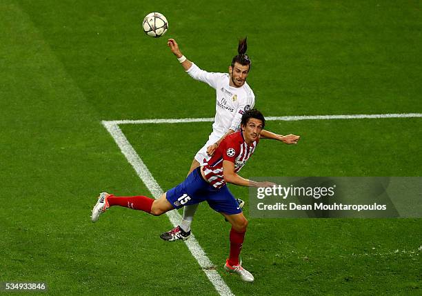 Gareth Bale of Real Madrid is challenged by Stefan Savic of Atletico Madrid during the UEFA Champions League Final match between Real Madrid and Club...