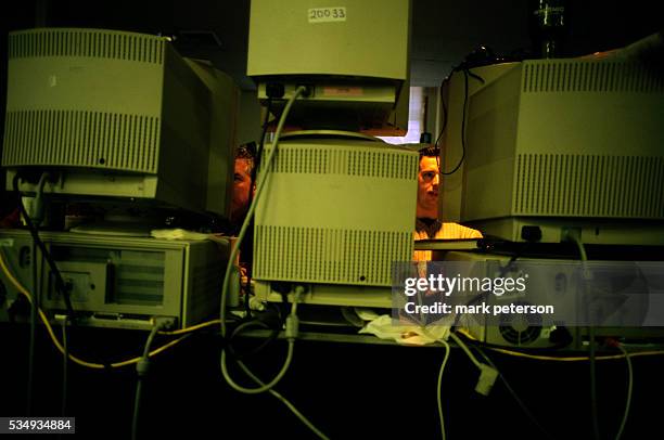 Stock exchange traders work on their computers at 50 Broad Street in Manhattan. | Location: Financial District, Lower Manhattan, New York, USA.