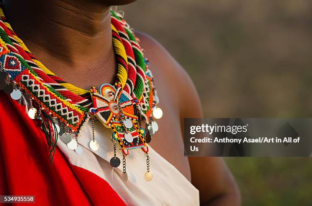 Kenya, Laikipia, Il Ngwesi, Masai man wearing traditional clothes and adorned with elaborate beadwork jewellery