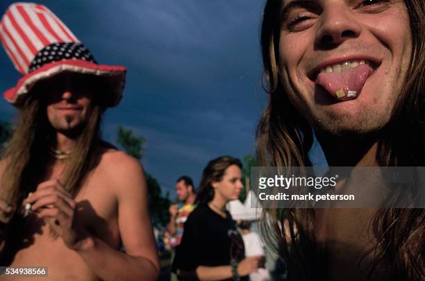 Saugerties, New York: Woodstock 94 - LSD tabs on tip of young man's tongue.