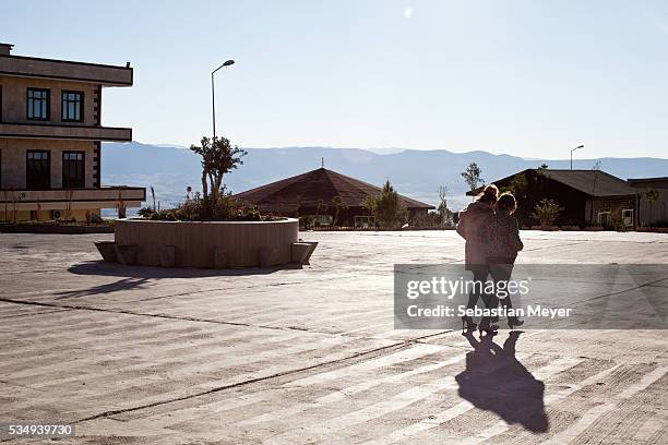 Two students walk across the new campus of Sulaimaniyah University.