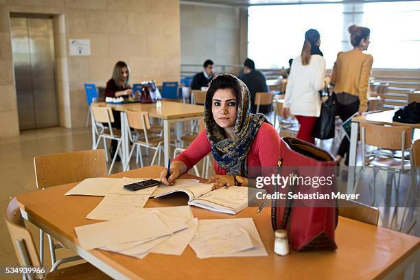 Student studies in the cafeteria at the American University of Iraq, Sulaimani .