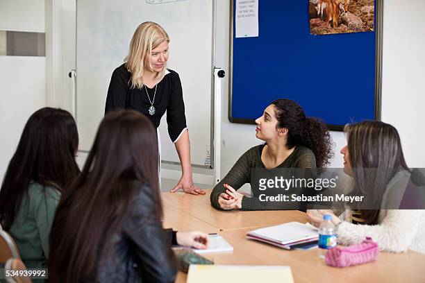 An English teacher talks to students in her class at the American University of Iraq, Sulaimani .