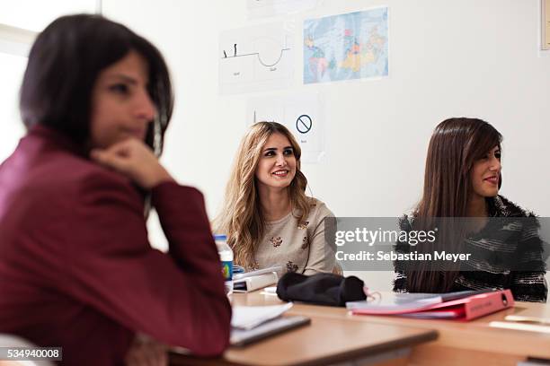 Students listen to a presentation by their teacher during their English class at the American University of Iraq, Sulaimani .