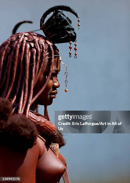 Angola, Southern Africa, Cunene, himba woman wearing western pendants