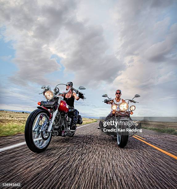 couple riding motorcycles - motociclista foto e immagini stock