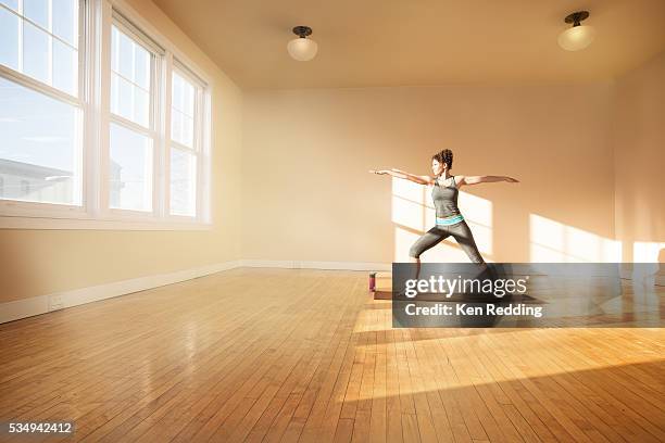 young woman practicing yoga - mat stock pictures, royalty-free photos & images