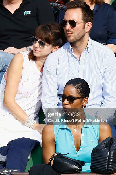 Christophe Michalak and Delphine McCarty attend the Jo Wilfied Tsonga match during the French Tennis Open at Roland Garros on May 28, 2016 in Paris,...