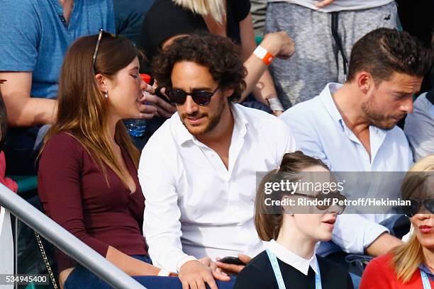 Thomas Hollande and his girlfriend attend the Jo Wilfied Tsonga match during the French Tennis Open at Roland Garros on May 28, 2016 in Paris, France.