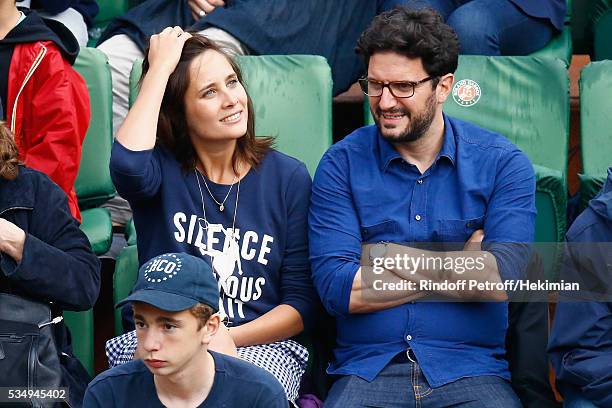 Julie de Bona and her boyfriend attend the Jo Wilfied Tsonga match during the French Tennis Open at Roland Garros on May 28, 2016 in Paris, France.