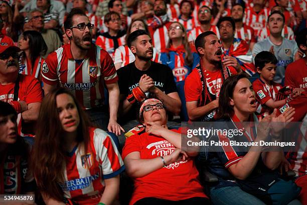Atletico de Madrid fans react as they watch the UEFA Champions League Final match between Real Madrid CF and Club Atletico de Madrid at Barclaycard...