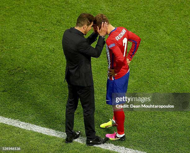 Antoine Griezmann of Atletico Madrid speaks to head coach Diego Simeone during the UEFA Champions League Final match between Real Madrid and Club...