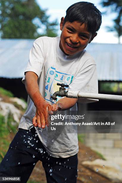 Guatemala, Quetzaltenango, San Juan Ostuncalco, schoolboy washing hands . UNICEF focus their efforts to ensure that boys and girls have access to...