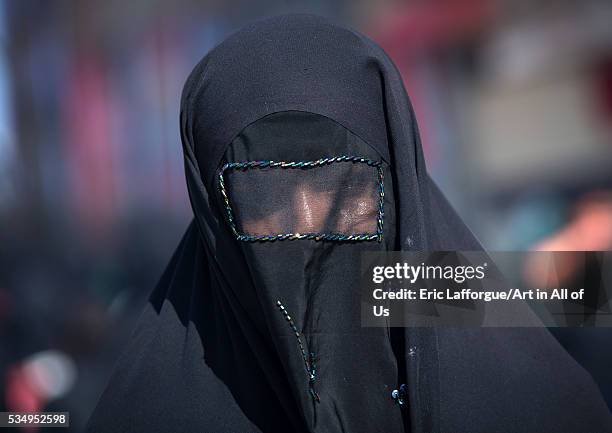 Iran, Lorestan Province, Khorramabad, iranian shiite muslim woman mourning imam hussein on the day of tasua with her face covered by a veil