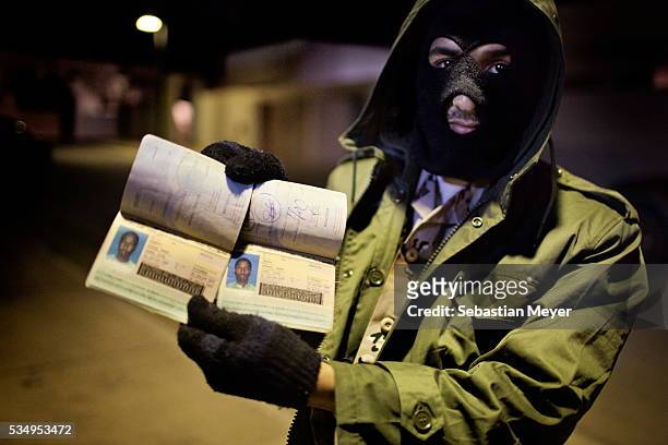 Rebel fighter displays the passports of two dead Chadians accused of being mercenaries for pro-Gaddafi forces. Libyan rebels fought a bloody 9 month...