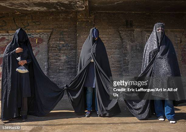 Iran, Lorestan Province, Khorramabad, iranian shiite women mourning hussein on tasua day with their faces covered and their clothes tied as they must...