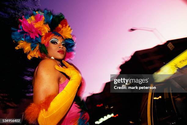 Man dons a feather headdress for the 2001 Wigstock, and annual drag festival held in Manhattan.