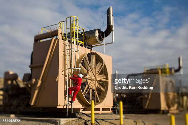 employee climbing on gas compressor equipment - kompressor bildbanksfoton och bilder