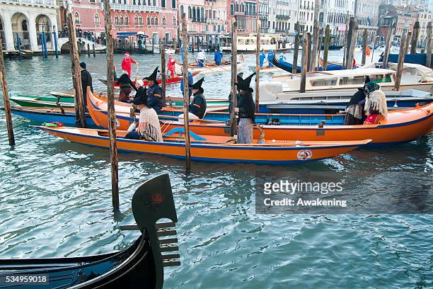 Participants dressed in costumes row a venetian boat to the Befana Regata on January 6, 2014 in Venice, Italy. In Italian folklore, Befana is an old...