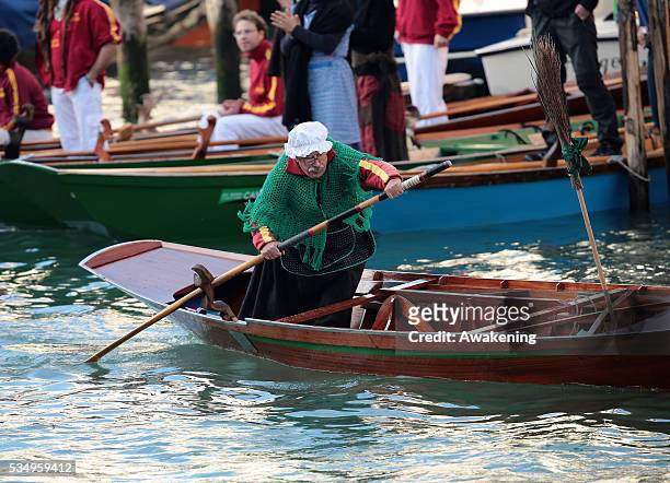 One of the costumed participants races along the Grand Canal for the 'Befana' Regatta on January 6, 2014 in Venice, Italy. In Italian folklore,...