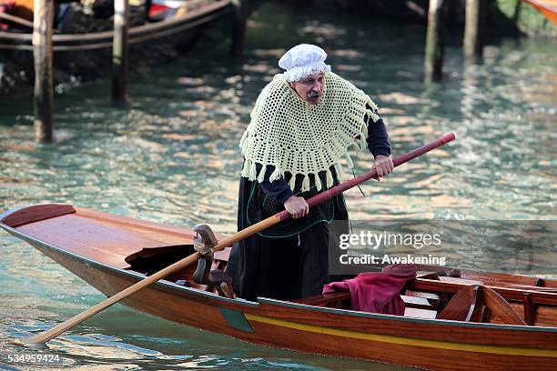 One of the costumed participants races along the Grand Canal for the 'Befana' Regatta on January 6, 2014 in Venice, Italy. In Italian folklore,...