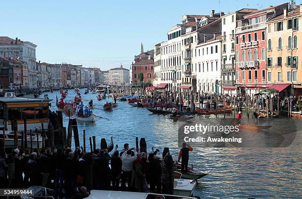 People and boats along the Grand Canal for the 'Befana' Regatta on January 6, 2014 in Venice, Italy. In Italian folklore, Befana is an old woman who...