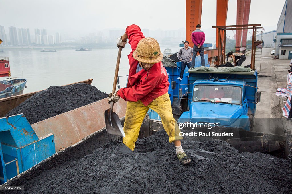 Worker Shovels Coal Dust, Chongqing, China