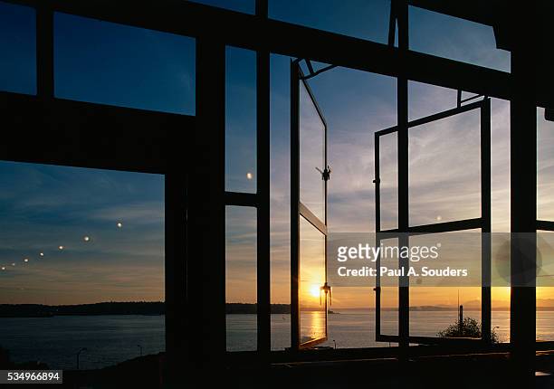 sunset reflected on windows - pike place market stock-fotos und bilder