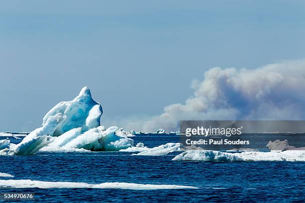 forest fire and sea ice, hudson bay, canada - hudson bay stock-fotos und bilder